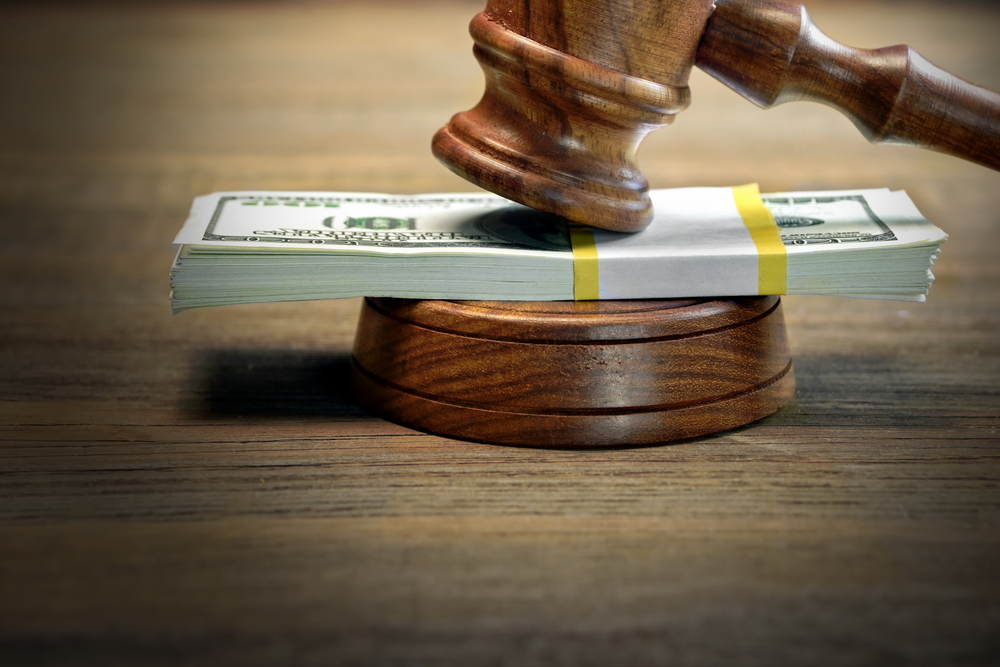 A gavel placed on top of a stack of money